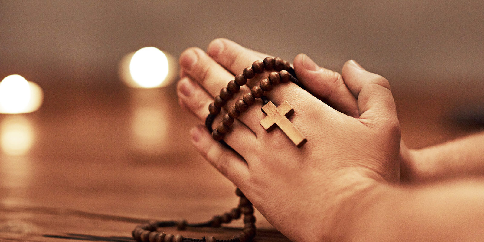 Hands in prayer with rosary