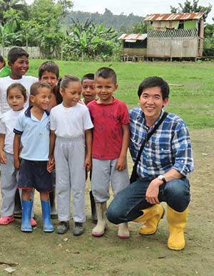 Khahn Ha on playground with local children in Ludo, Ecuador