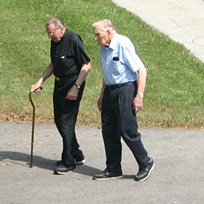 Retired priests walking along the grounds at Society of the Divine Word