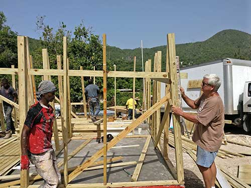 Brother_Bernie_Working_on_House_Frame_With_Worker.jpg