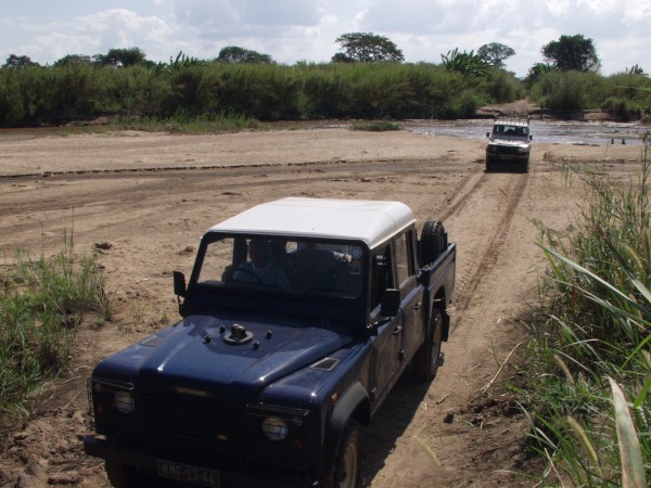 Missionary driving truck through rough terrain