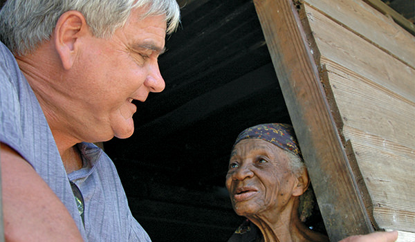 Brother Bernie checking on a local elderly woman in Jamaica - Society of the Divine Word Chicago Province