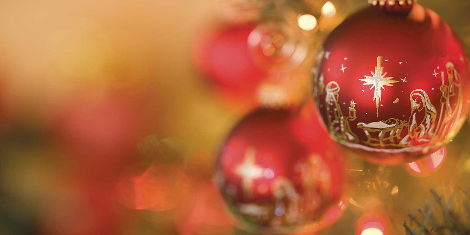 Christmas ornament hanging on tree with the child Jesus, Mary and Joseph
