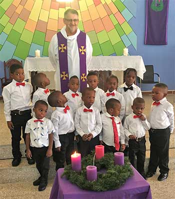 Kindergarten kids in Jamaica with Father Bernard Latus from Society of the Divine Word Chicago Province