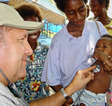 Brother Doctor Jezry Kuzzman providing medical exams to children at refugee camp