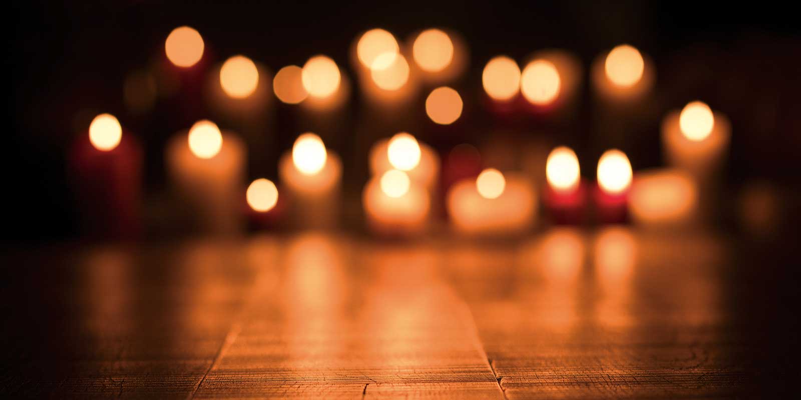 Candles glowing in the dark for All Souls