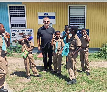 Father Bernard Latus and students at Portmore Primary School in Jamaica