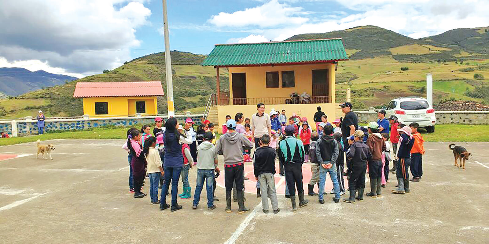Missionary Ha Khahn with local children and residents at playground in Ludo, Equador
