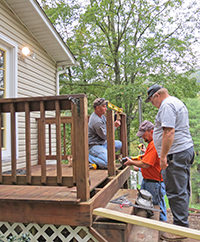 Parish volunteers help a local resident with home repairs.