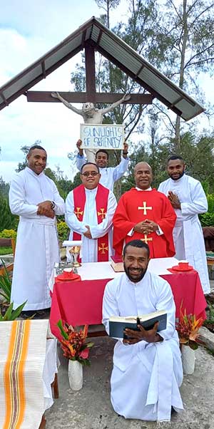 Novices during spirituality retreat standing with sign that says Sunlights of Serenity
